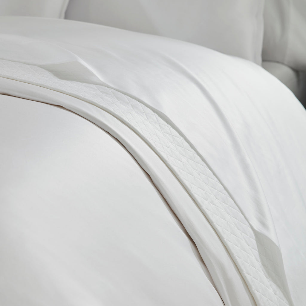 Giza 45 Corto Sateen Duvet Cover, Sheets, and Shams in White from luxury bedding designer Sferra Fine Linens