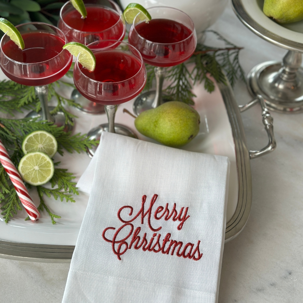 Arte Italica Merry Christmas Linen Towel in White linen with red script font embroidery