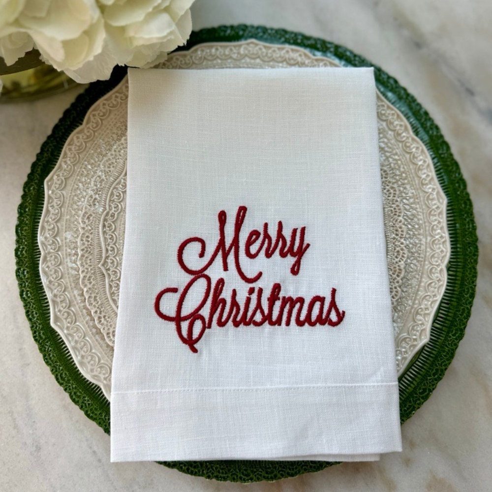 Arte Italica Merry Christmas Tri-Fold Napkin in White linen with red embroidered "Merry Christmas" in script font