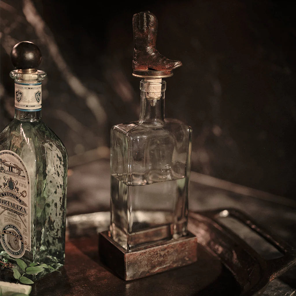 Jan Barboglio Wayne glass decanter with iron cowboy boot stopper